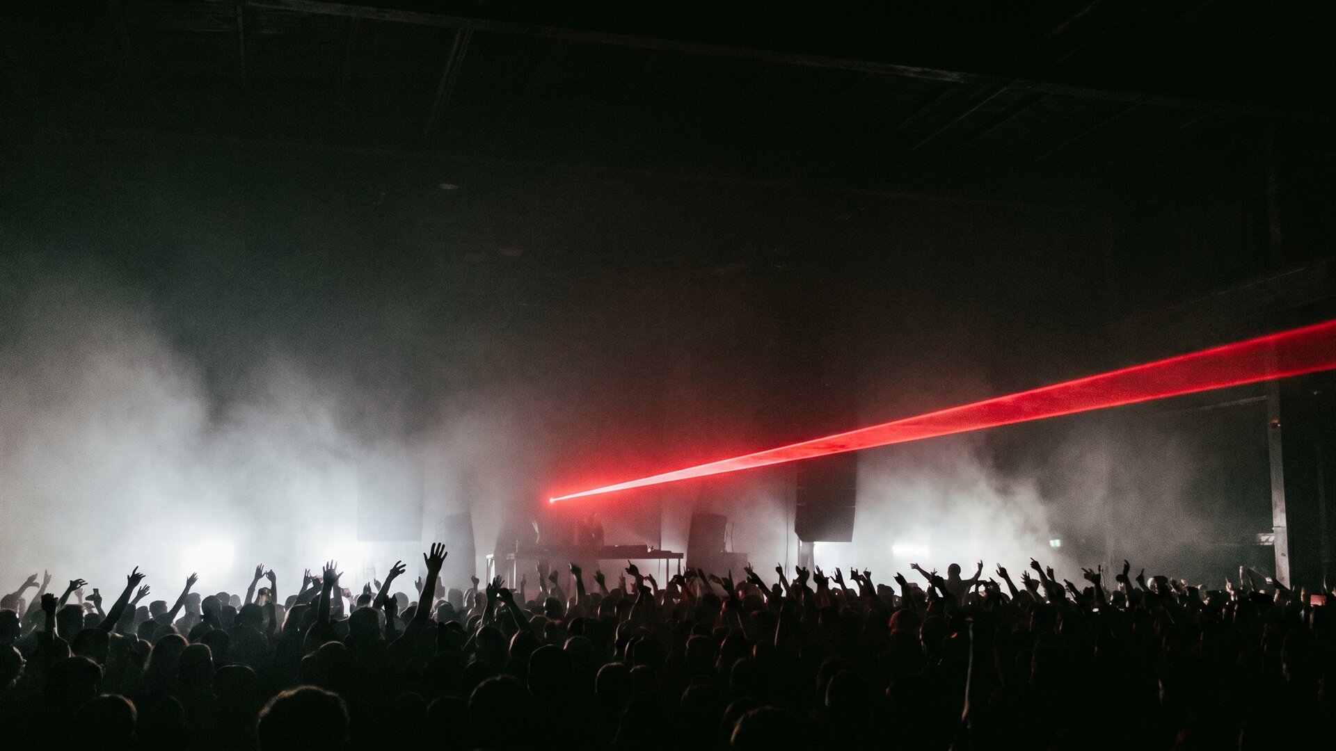 NULLTAG · dark rave venue, red laser beam through fog